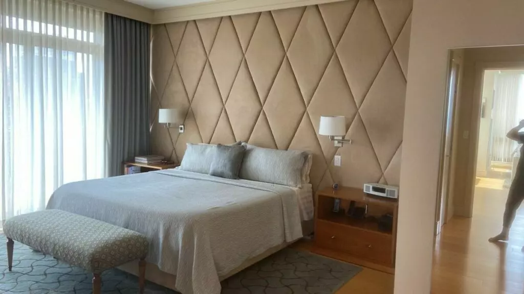 A Boston bedroom with a bed and a bedside table.