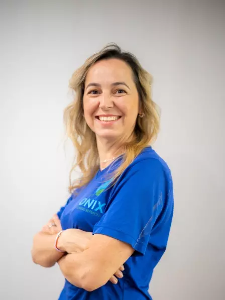 A smiling woman in a blue t-shirt providing maid service Boston.