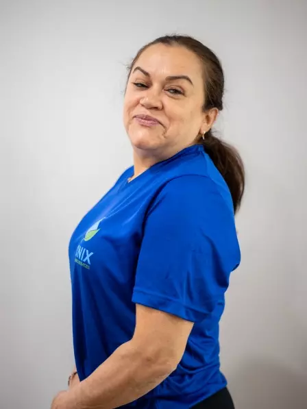 A woman in a blue t-shirt posing for a photo in Boston.