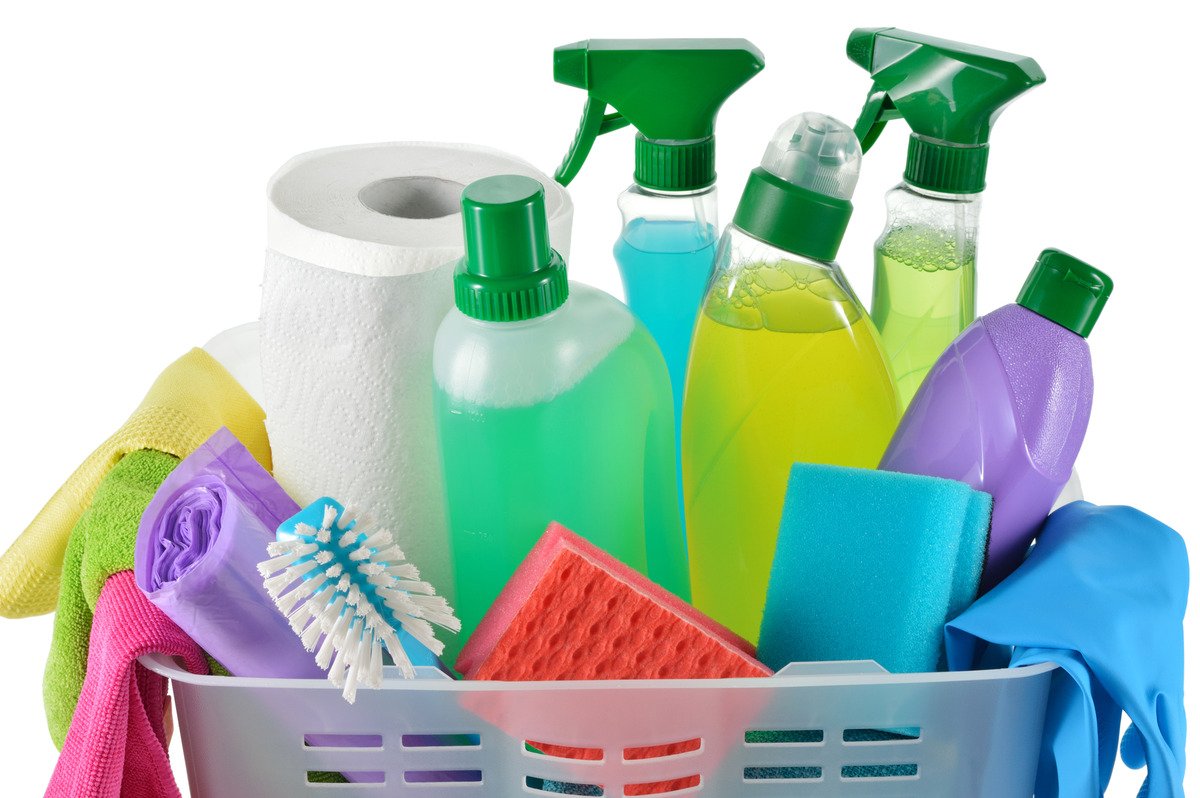 Kitchen Surface Cleaners ; an image of a white background with a basket overflowing with assorted cleaning products