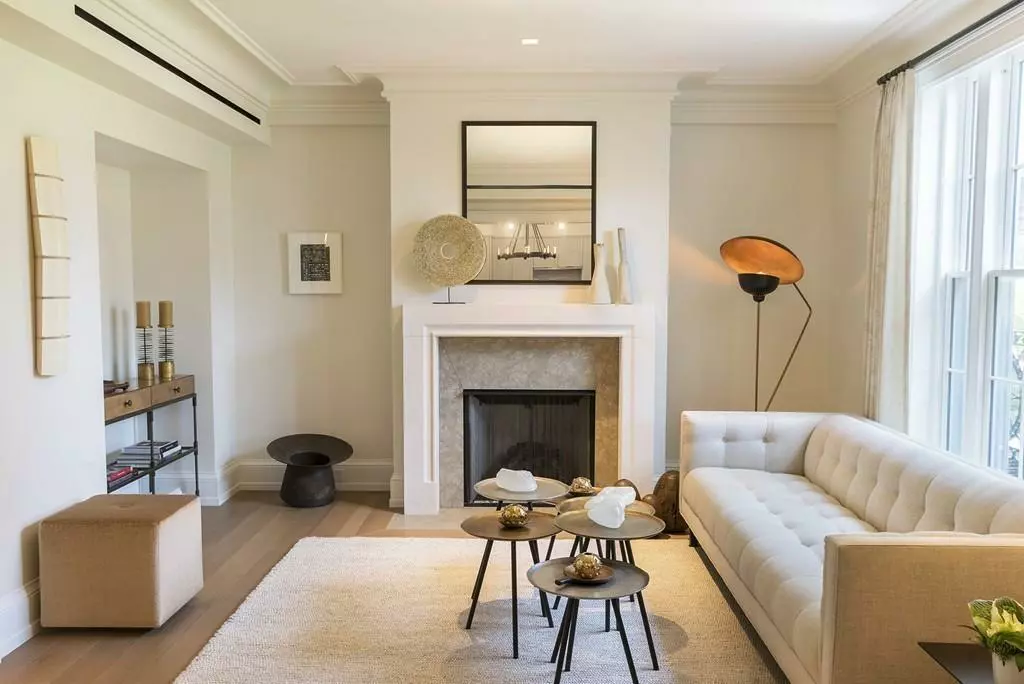 Elegant living room with a white fireplace, beige sofa, and modern decor including living room cleaning templates.