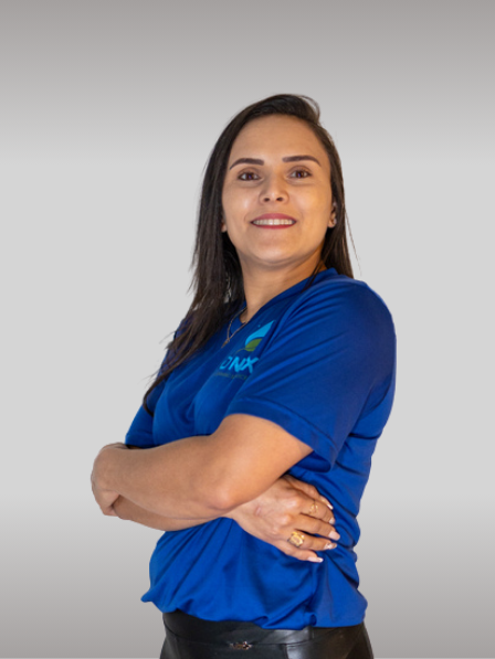 A person wearing a blue shirt stands with arms crossed and smiles at the camera, representing the professionalism and friendliness associated with Onix Cleaning Services, against a gray background.